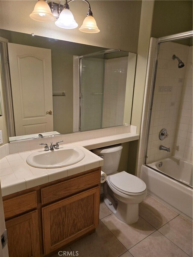 full bathroom with enclosed tub / shower combo, vanity, toilet, and tile patterned flooring