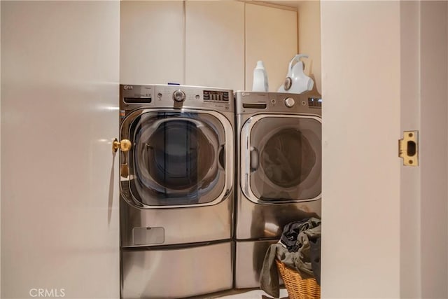 clothes washing area featuring washer and clothes dryer