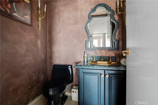 bathroom featuring vanity and toilet