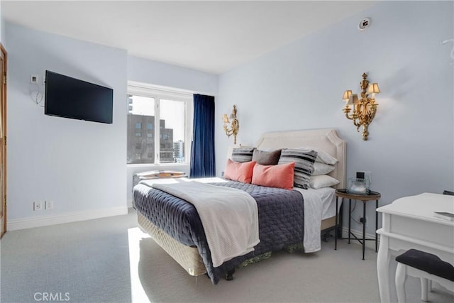 bedroom featuring light carpet