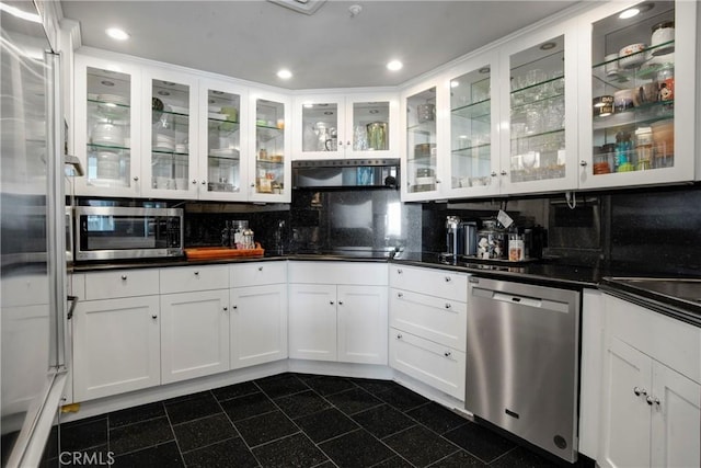 kitchen featuring appliances with stainless steel finishes, white cabinets, and backsplash