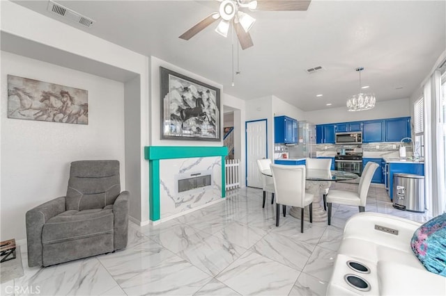 dining space with ceiling fan with notable chandelier