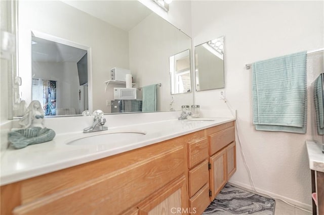 bathroom with tile patterned flooring and vanity