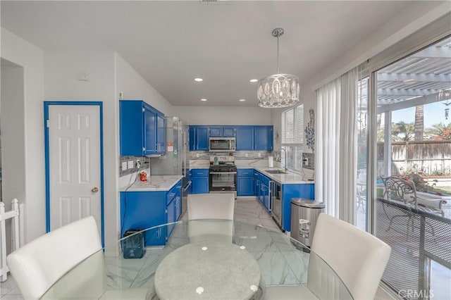 dining area featuring an inviting chandelier and sink