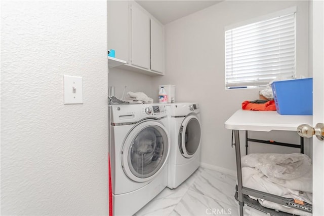 laundry area featuring cabinets and washer and dryer