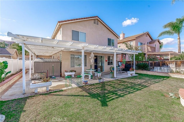 rear view of property featuring a storage unit, a lawn, a patio area, and a pergola