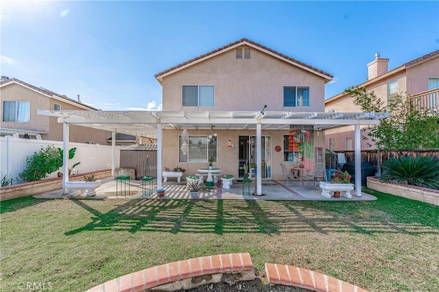 back of property with a yard, a pergola, and a patio