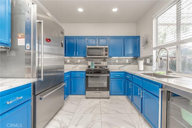 kitchen featuring wine cooler, blue cabinetry, stainless steel appliances, and sink