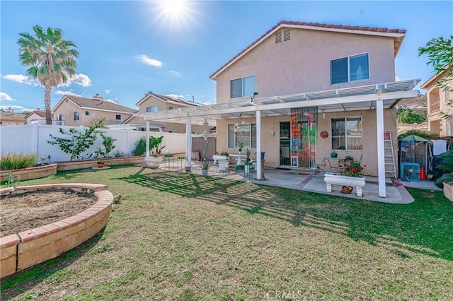 rear view of property featuring a lawn, a patio area, and a pergola