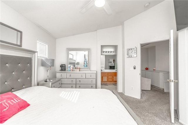 bedroom with vaulted ceiling, light colored carpet, ceiling fan, and ensuite bathroom