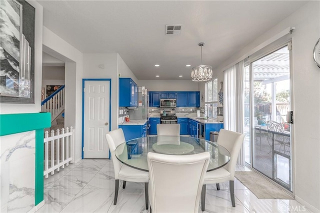 dining room featuring a chandelier and sink