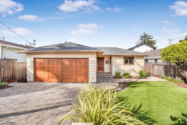 view of front of property with a garage and a front yard