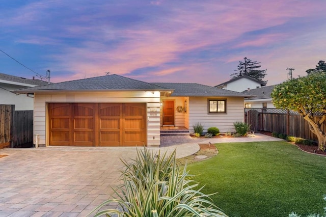 view of front of home featuring a yard and a garage