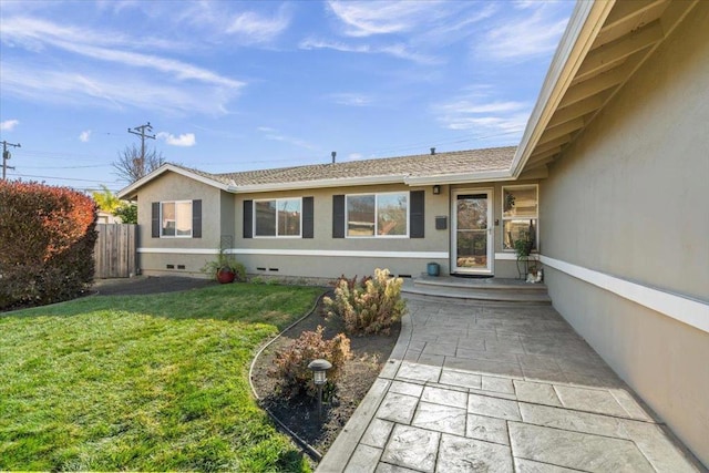 entrance to property featuring a yard