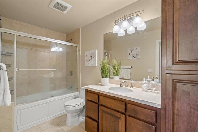 full bathroom with vanity, tile patterned floors, enclosed tub / shower combo, and toilet