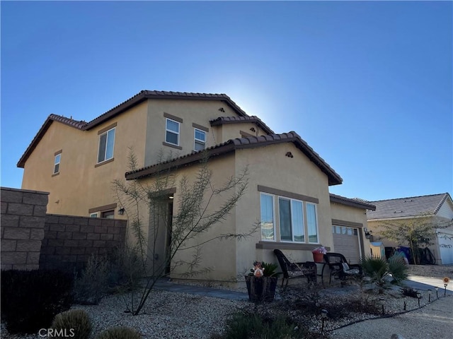 back of property featuring a garage