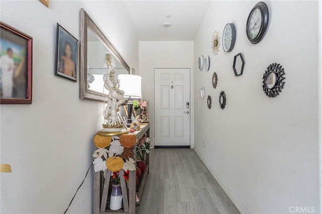 corridor with light hardwood / wood-style floors