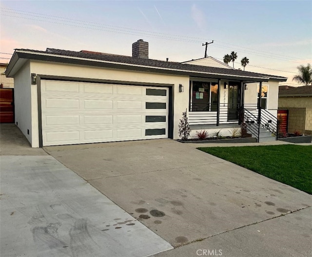 ranch-style home with a garage and covered porch