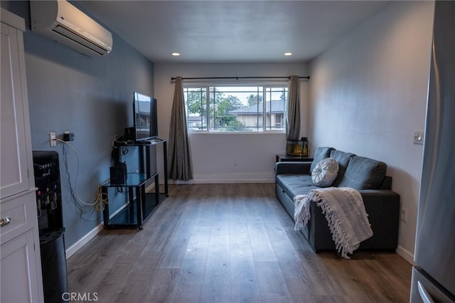 sitting room featuring dark wood-type flooring and a wall mounted air conditioner