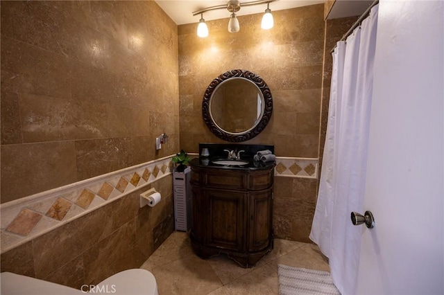 bathroom featuring tile walls, vanity, and tile patterned flooring