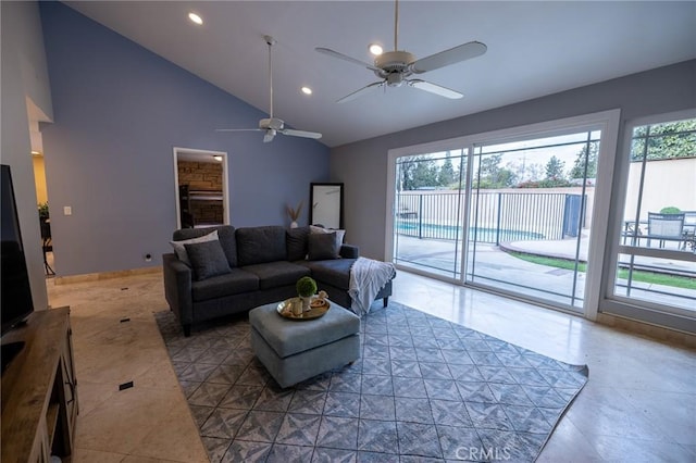 living room with vaulted ceiling, plenty of natural light, and tile patterned floors