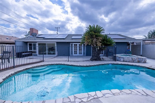 view of swimming pool featuring a patio and an in ground hot tub