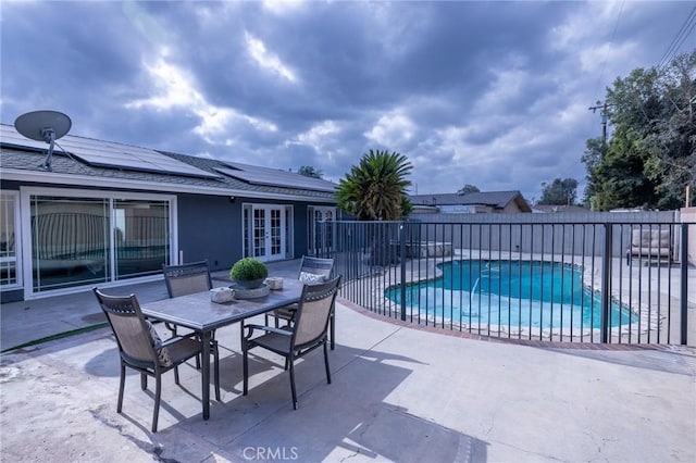 view of patio / terrace with a fenced in pool and french doors