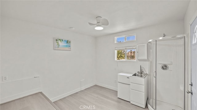 bathroom with vanity, wood-type flooring, ceiling fan, and walk in shower