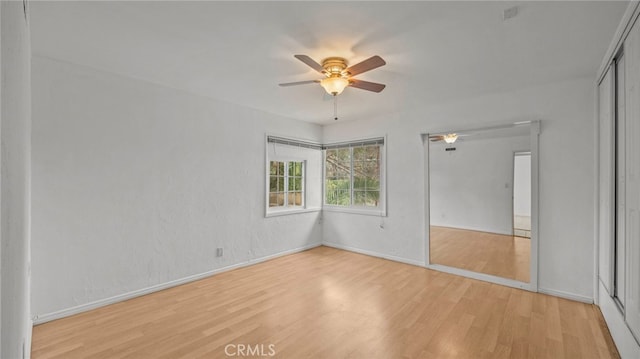 spare room featuring ceiling fan and light wood-type flooring