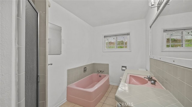 bathroom featuring vanity, plenty of natural light, shower with separate bathtub, and tile patterned floors