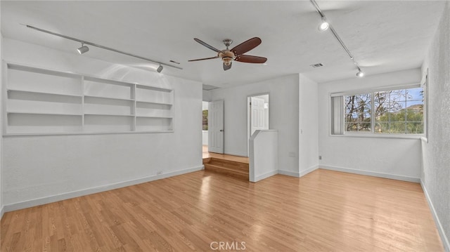 unfurnished living room with ceiling fan, track lighting, and light hardwood / wood-style floors