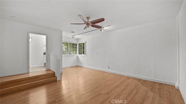 spare room featuring ceiling fan and light wood-type flooring