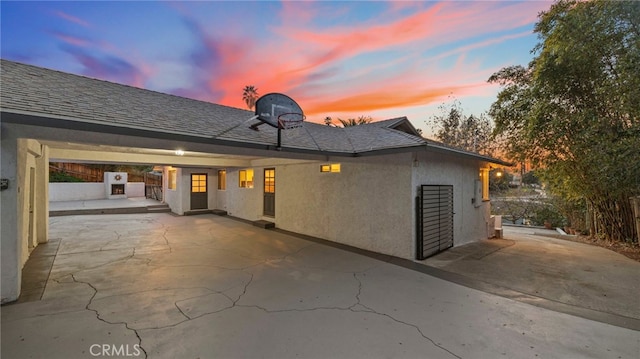 view of back house at dusk