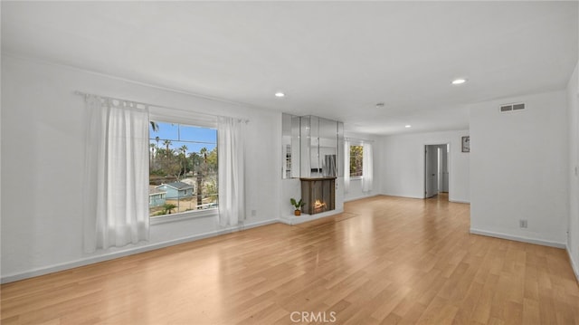 unfurnished living room with light hardwood / wood-style floors