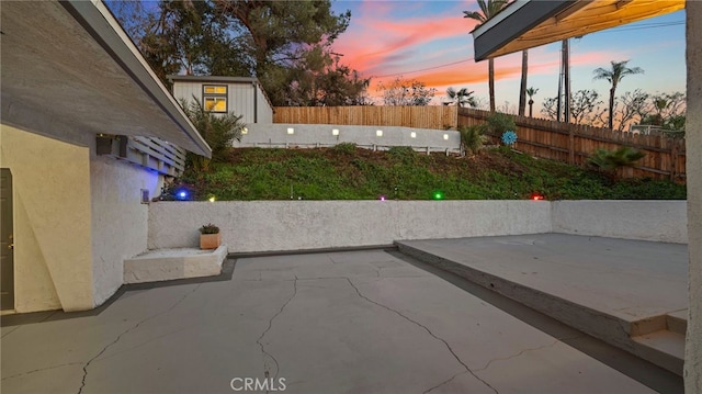 view of patio terrace at dusk