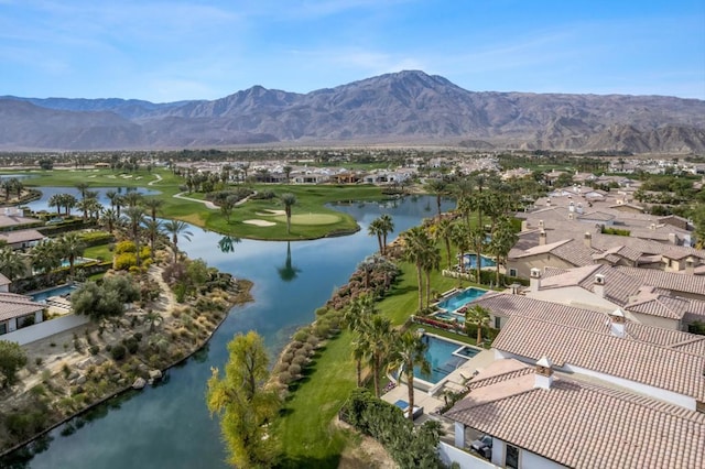 drone / aerial view featuring a water and mountain view