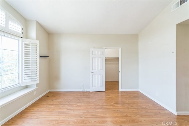 unfurnished room with light hardwood / wood-style flooring and a healthy amount of sunlight