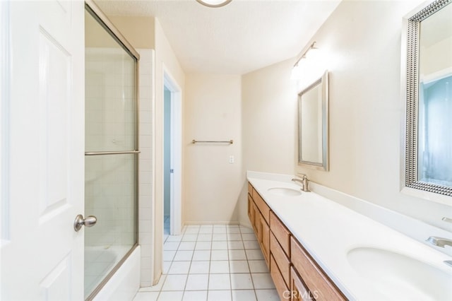 bathroom featuring vanity, tile patterned floors, shower / bath combination with glass door, and a textured ceiling