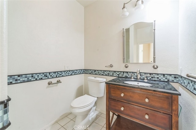 bathroom featuring vanity, tile patterned floors, and toilet