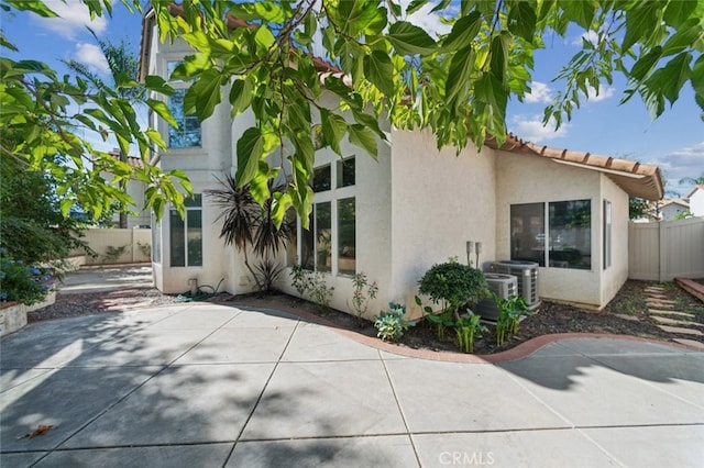 view of property exterior featuring central AC and a patio