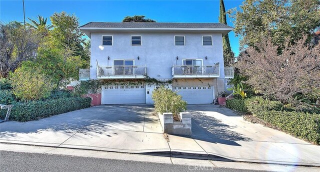 view of front of home with a balcony and a garage