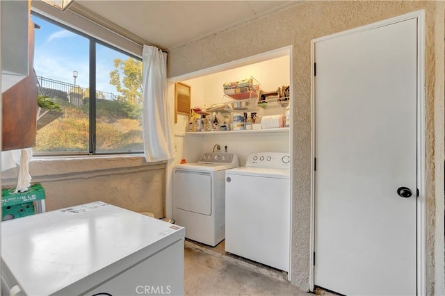 washroom with laundry area and separate washer and dryer