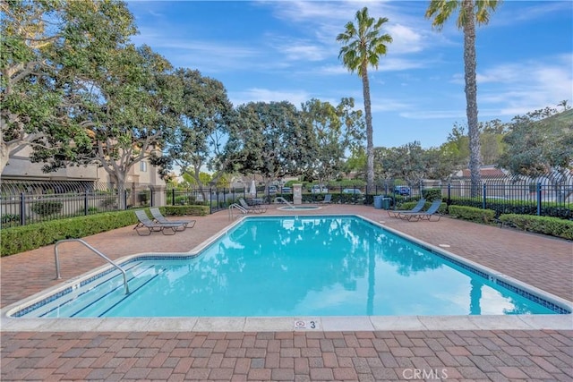 pool featuring a patio area and fence