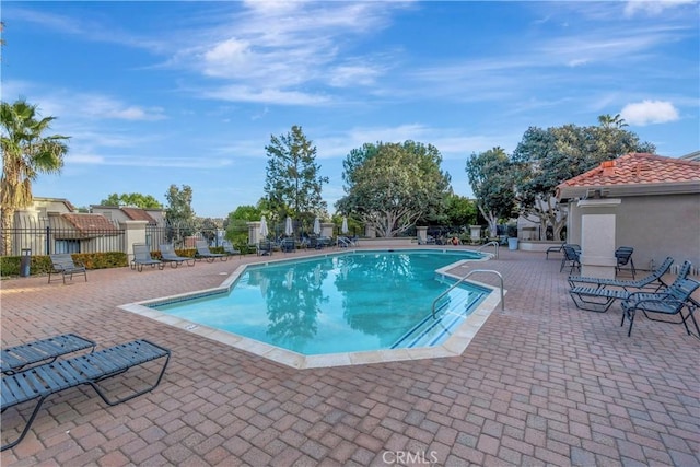 pool featuring a patio and fence