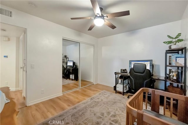 bedroom featuring baseboards, visible vents, a closet, and light wood-type flooring