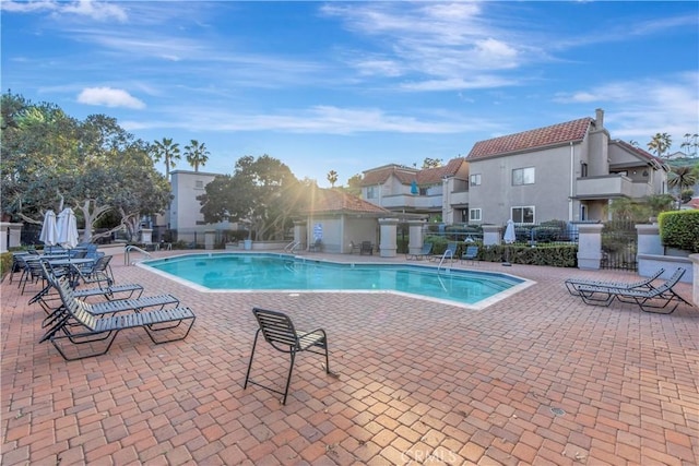 pool featuring a patio and fence