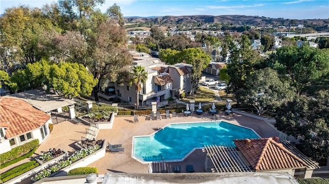 community pool featuring a mountain view and a residential view