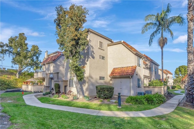 view of side of home featuring a lawn