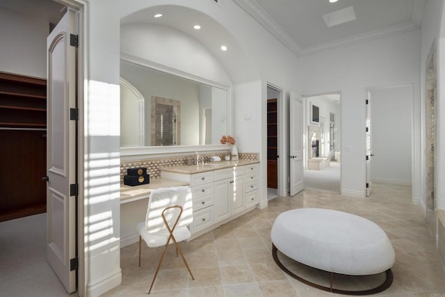 bathroom with walk in shower, decorative backsplash, ornamental molding, and vanity