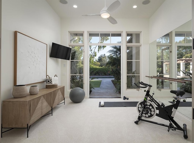 workout room with carpet, a healthy amount of sunlight, and ceiling fan